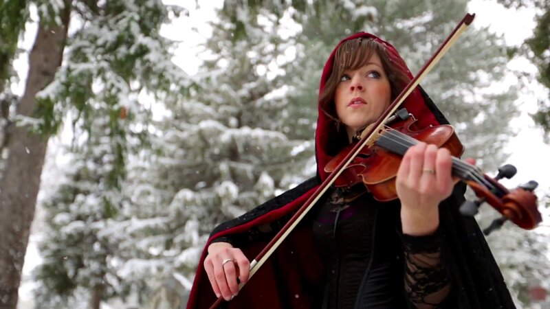 Woman playing violin in snow