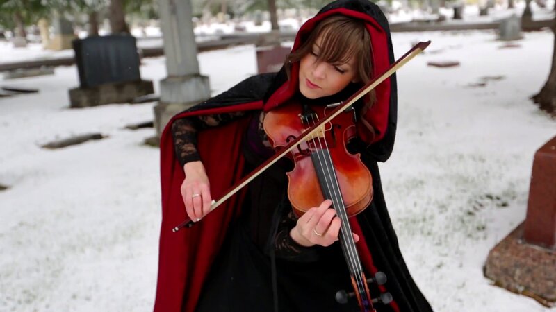 woman playing violin in snow