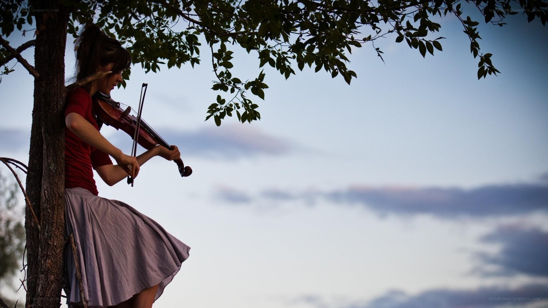 woman playing violin in tree