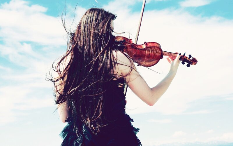 woman playing violin outdoors