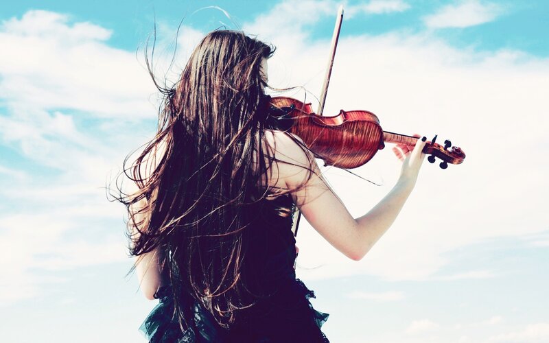 woman playing violin outdoors
