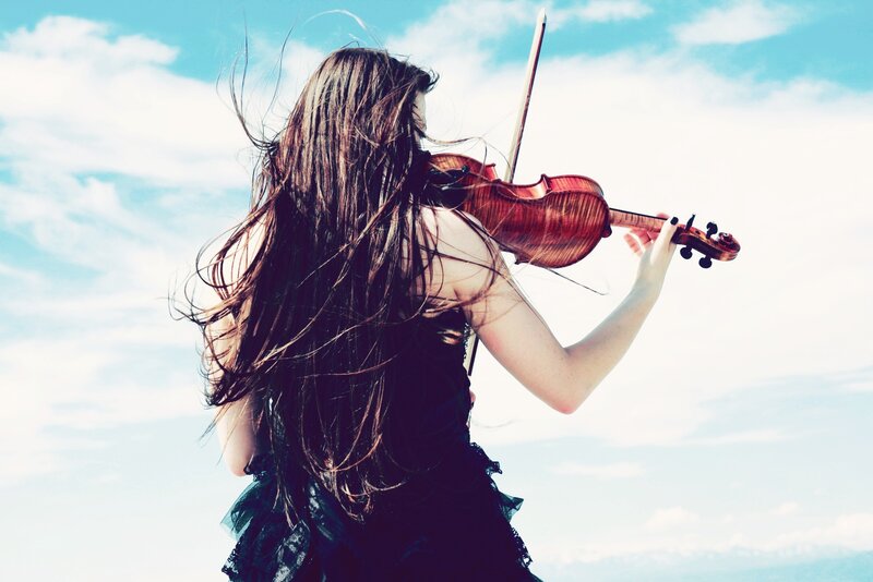 woman playing violin outdoors