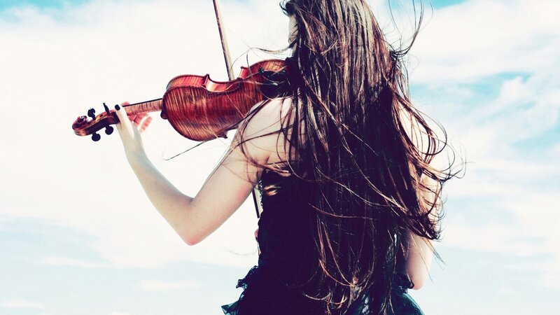 woman playing violin outdoors