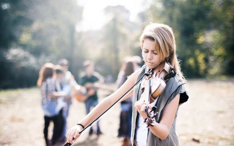 Woman playing violin outdoors