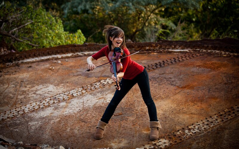 woman playing violin outdoors