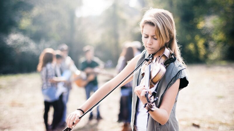 Woman playing violin outdoors