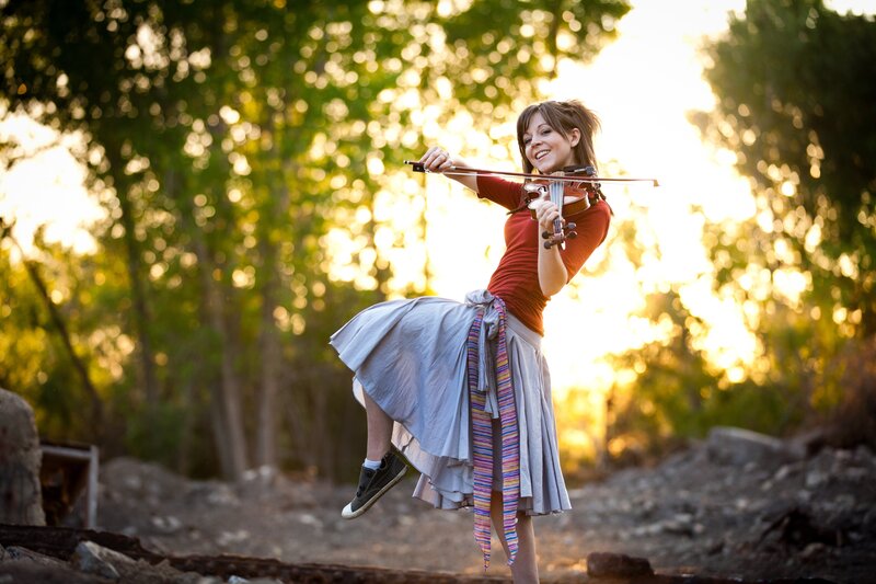 woman playing violin outdoors