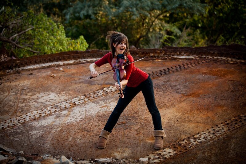 woman playing violin outdoors