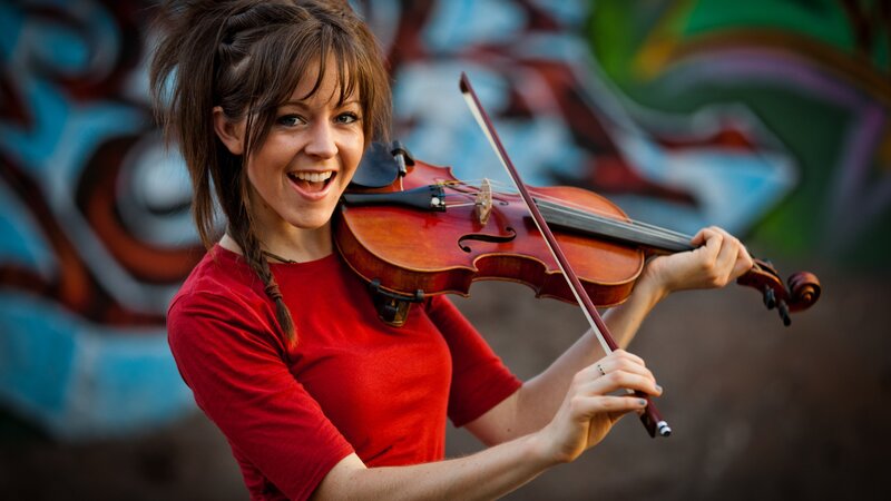 woman playing violin outdoors