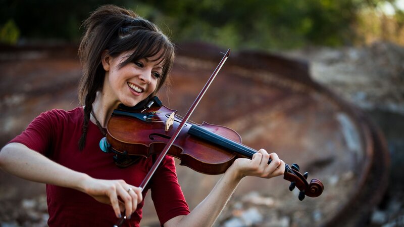 Woman playing violin outdoors