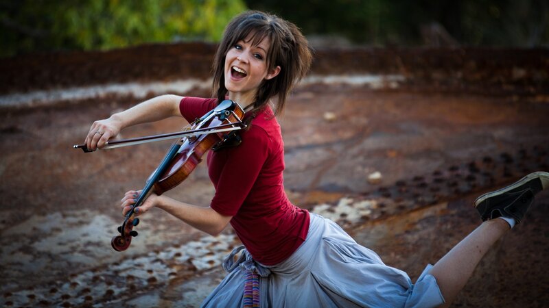 woman playing violin outdoors