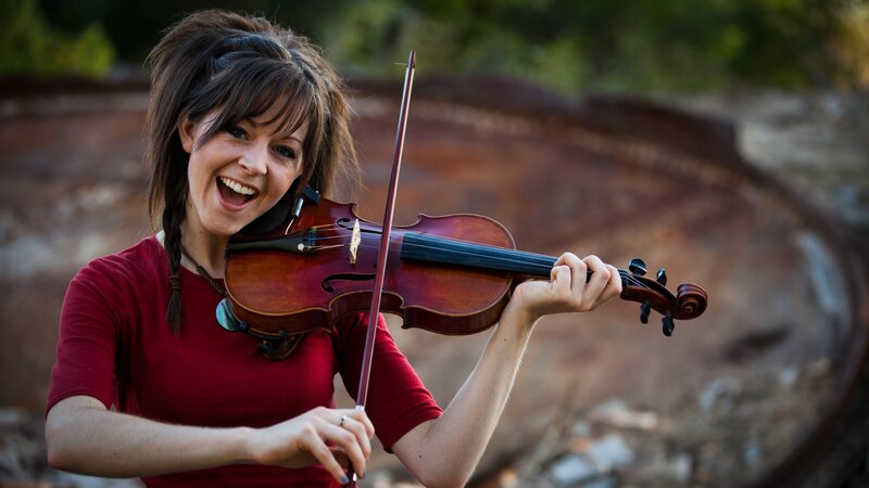 woman playing violin outdoors
