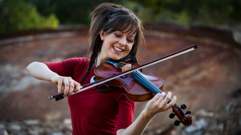 woman playing violin outdoors