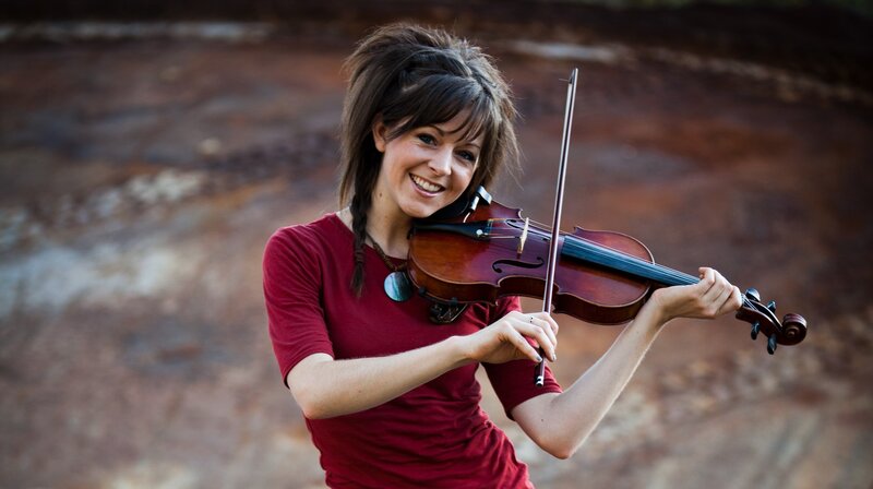 woman playing violin outdoors