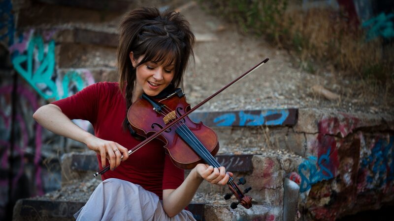 woman playing violin outdoors