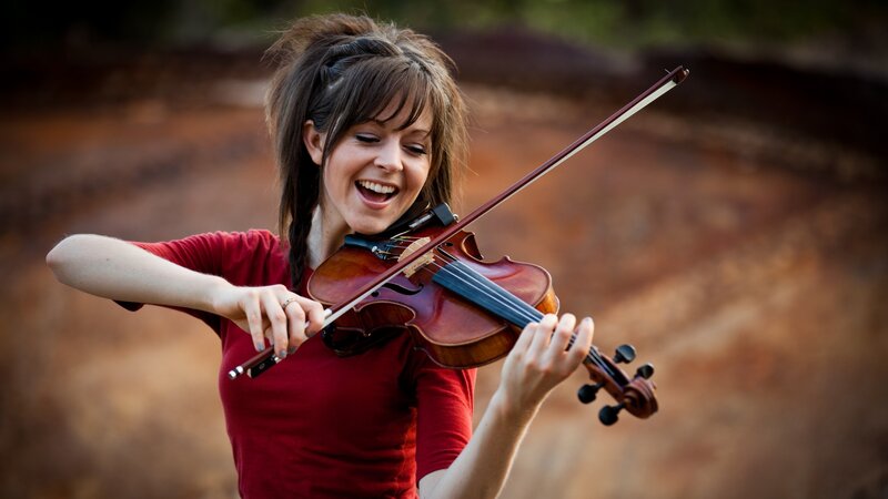 woman playing violin outdoors