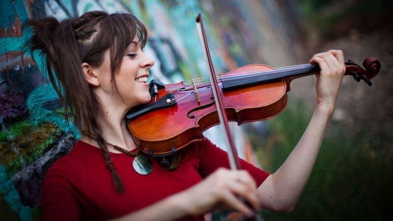 woman playing violin outdoors
