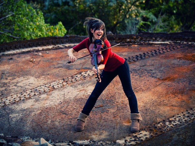 woman playing violin outdoors