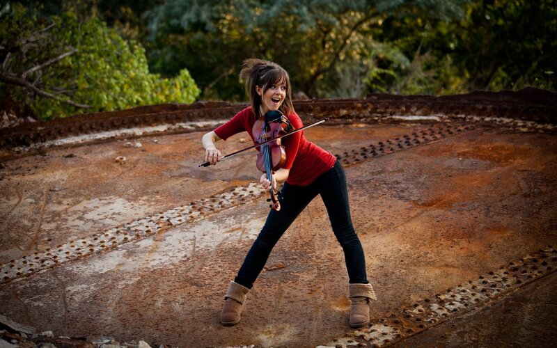 woman playing violin outdoors