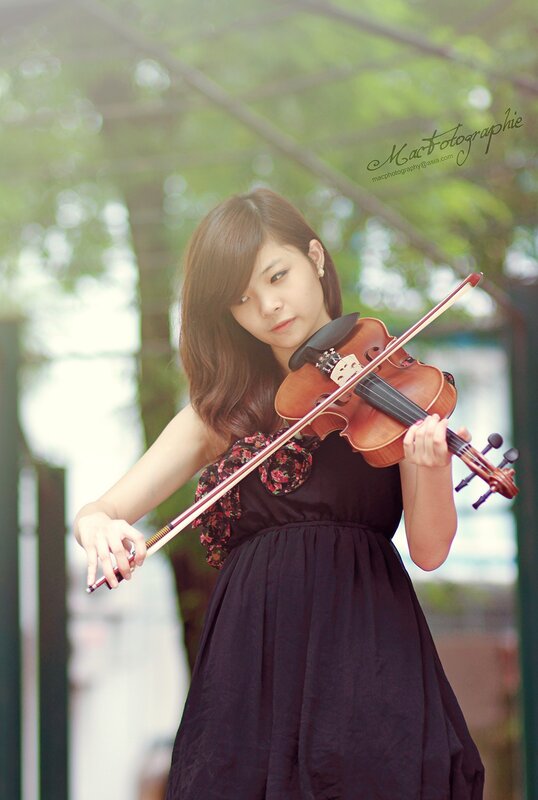woman playing violin outdoors
