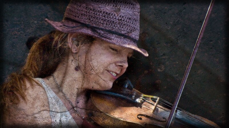 woman playing violin outdoors
