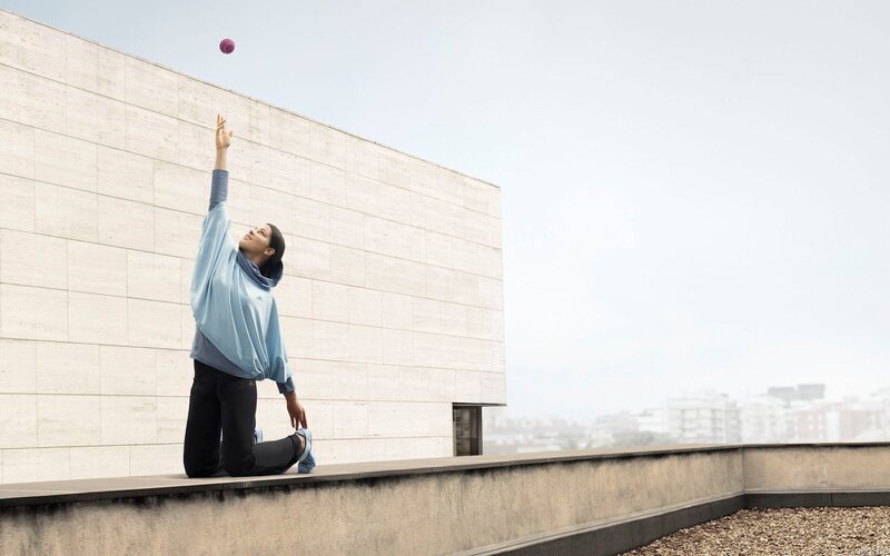 Woman playing with a ball on a rooftop