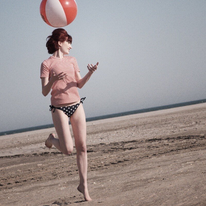 woman playing with beach ball