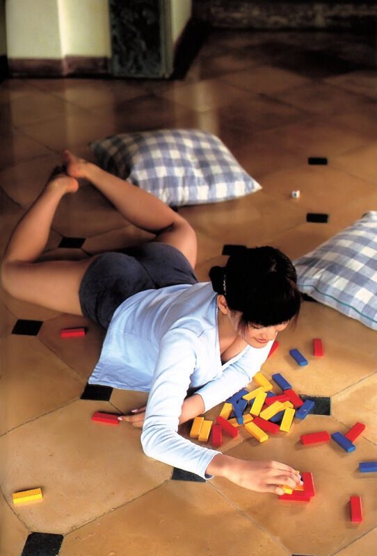 woman playing with blocks on floor