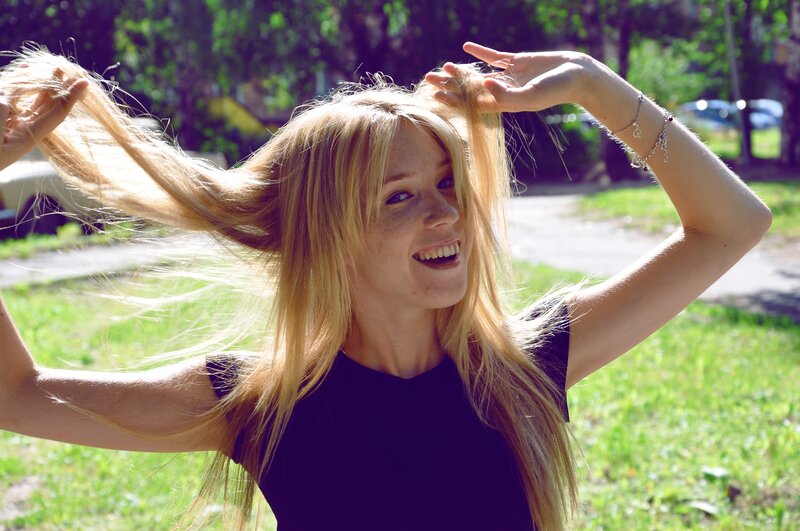 woman playing with blonde hair