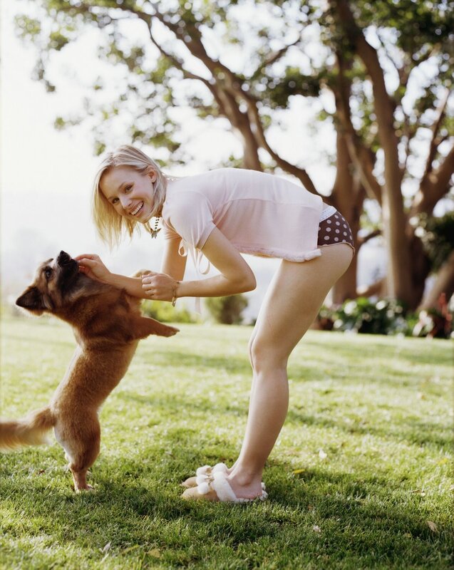 Woman playing with dog in garden