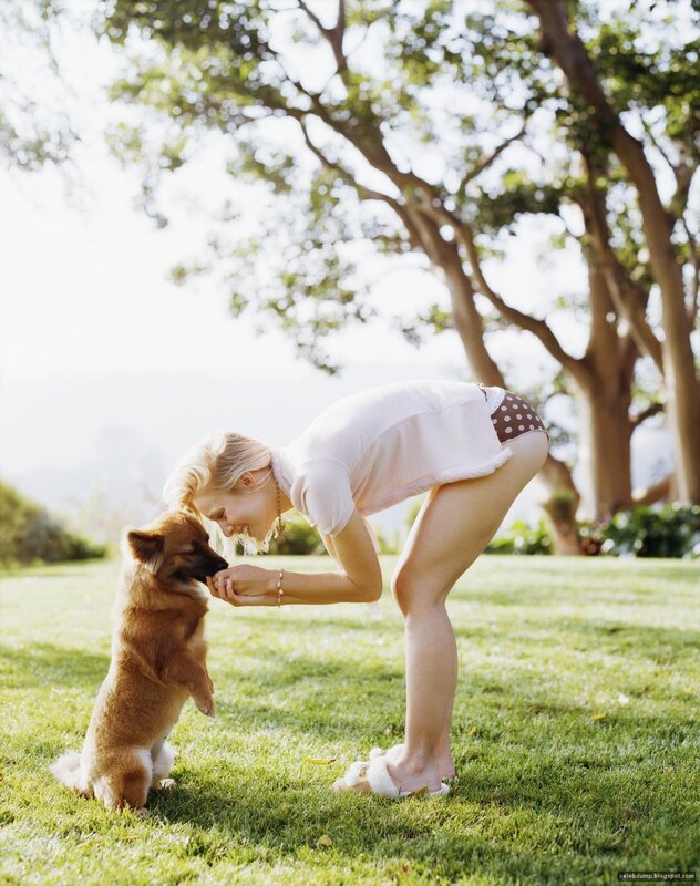 woman playing with dog in garden
