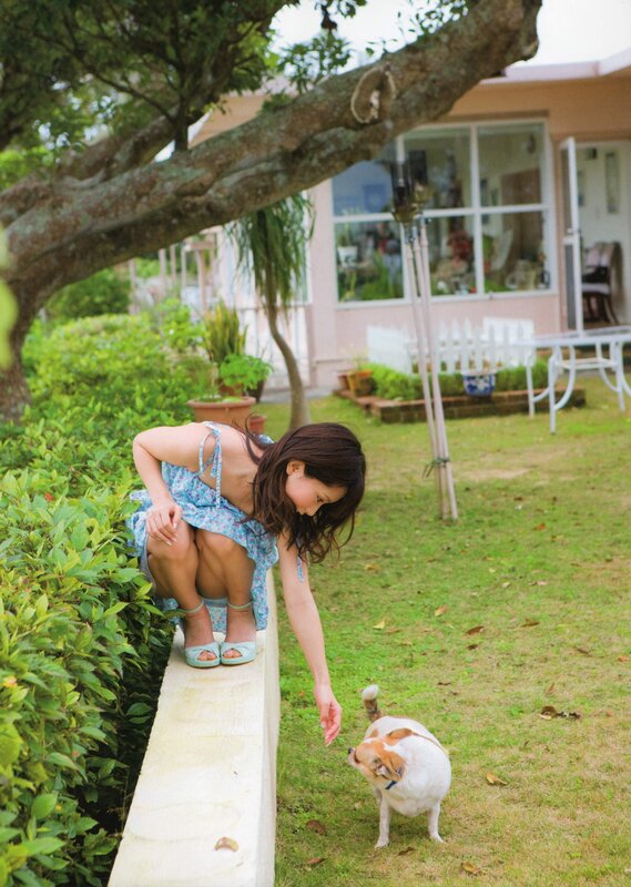 Woman playing with dog in garden