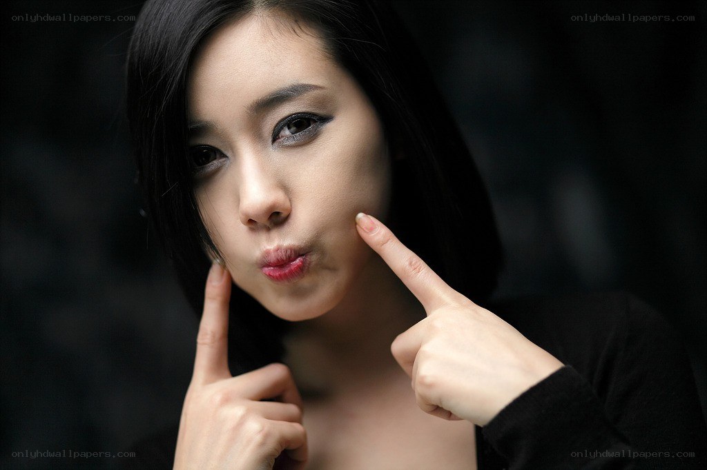 woman pointing at her face