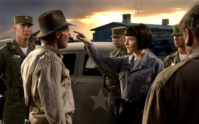 Woman pointing at man in military setting
