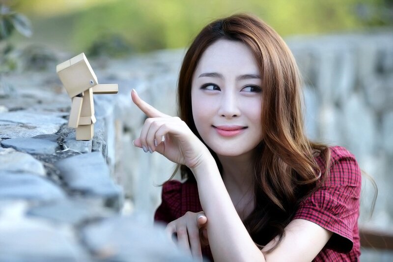 woman pointing at wooden figure