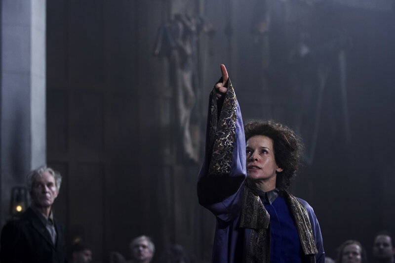 woman pointing in a dark hall
