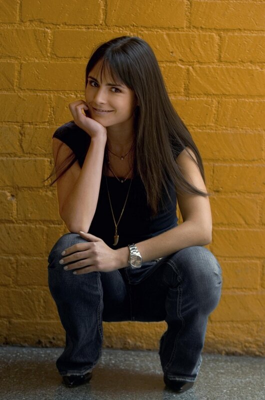 woman posing against yellow wall