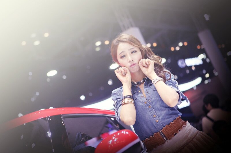 Woman Posing at Auto Show — Blue, Dramatic