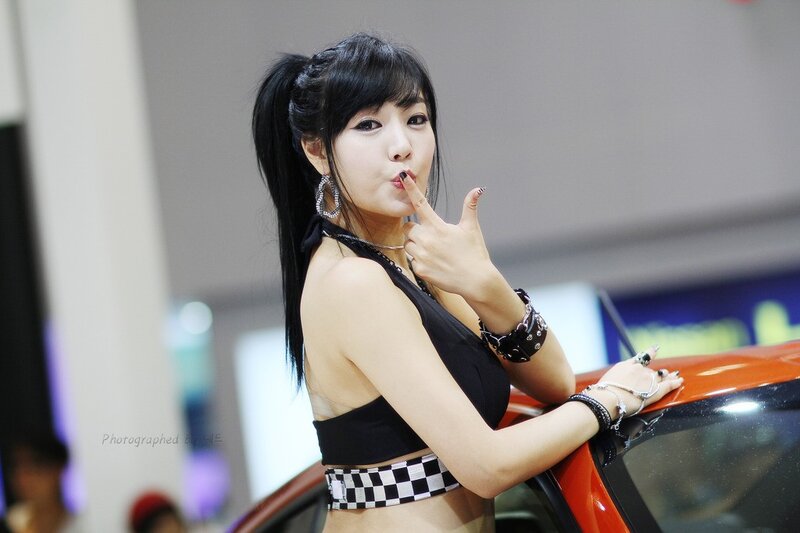 woman posing at car show
