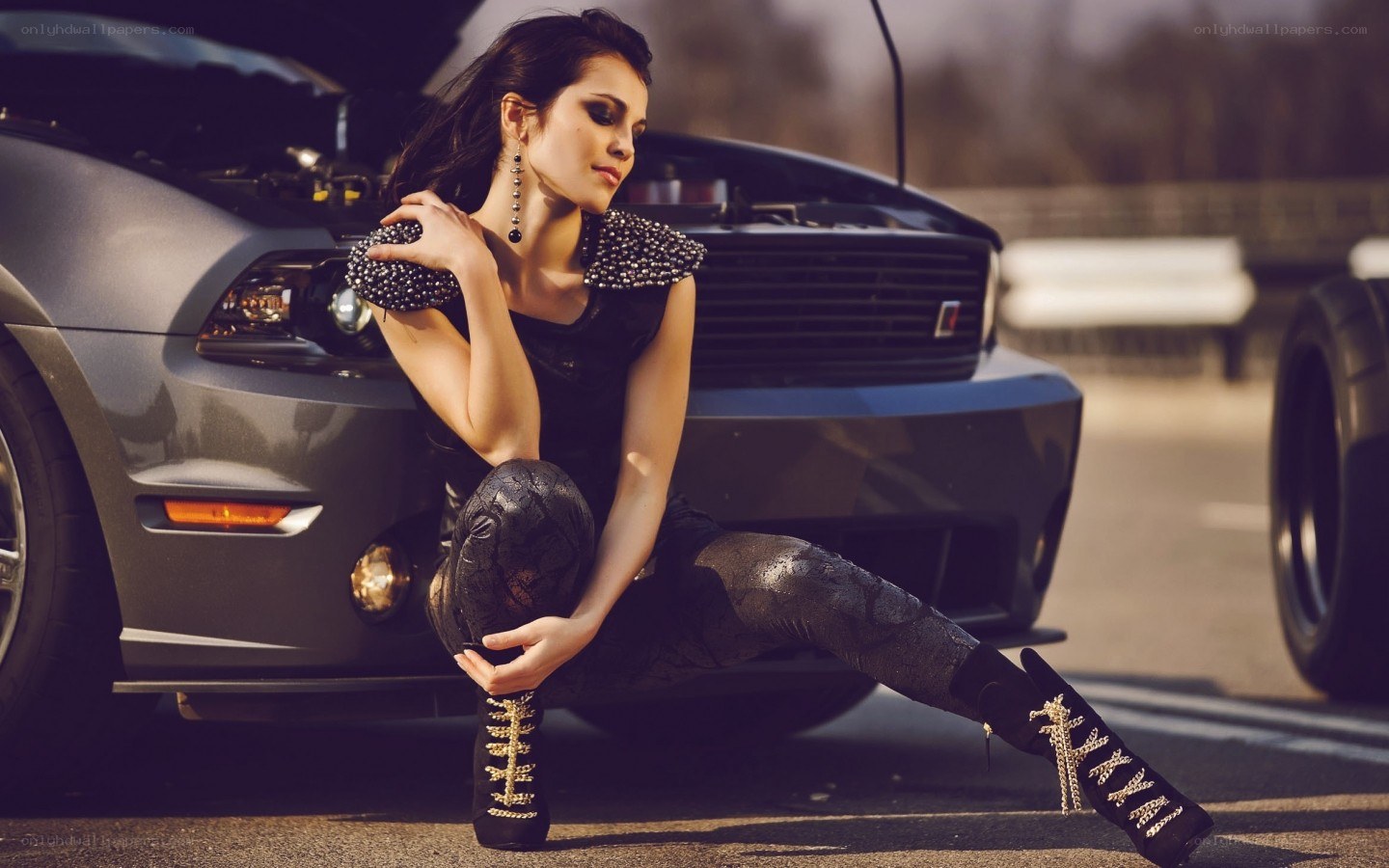 woman posing by a car