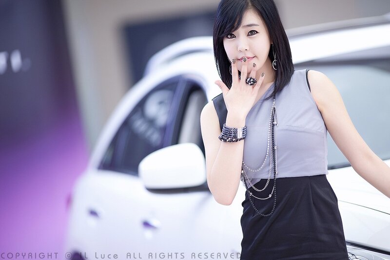 woman posing by a car
