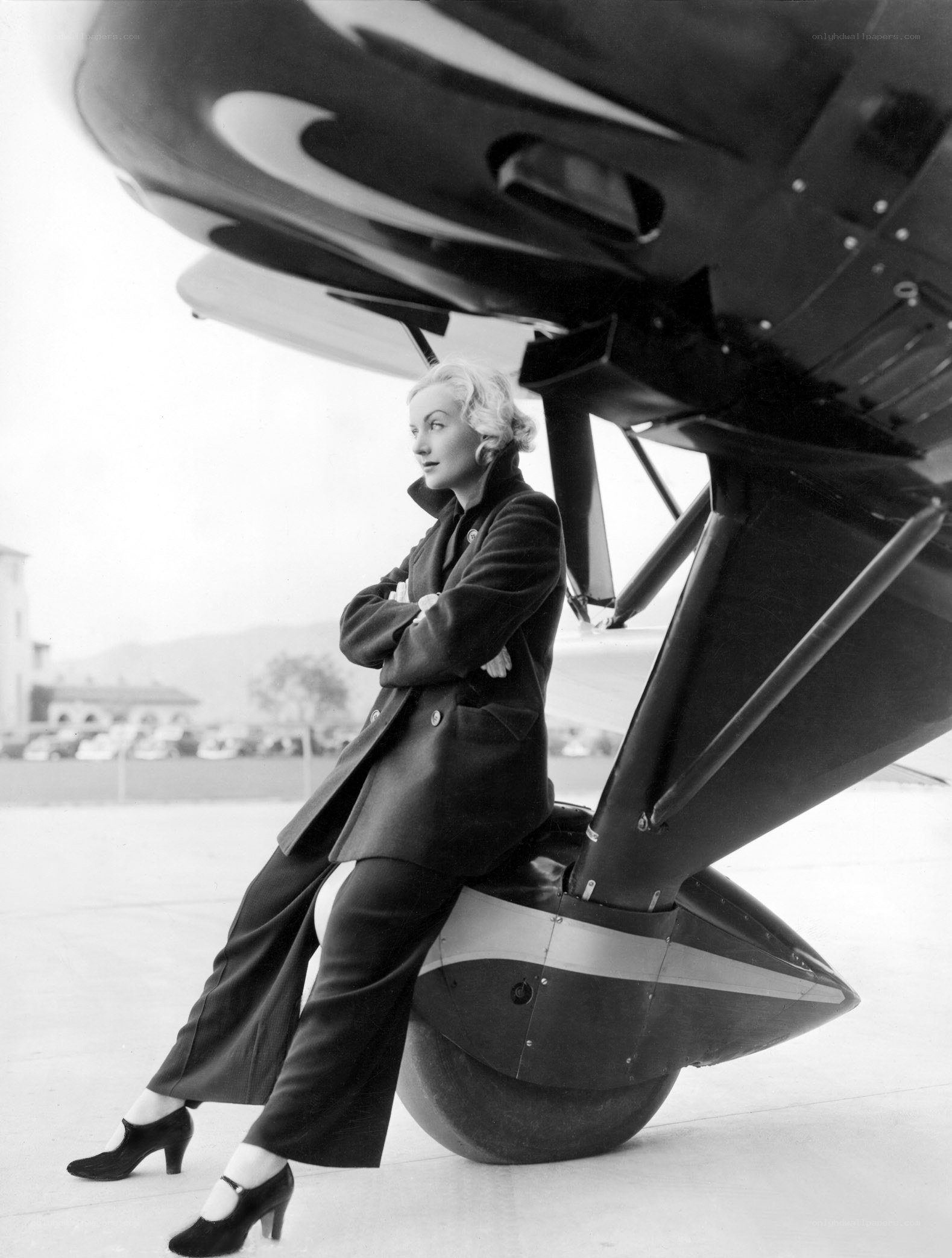 woman posing by airplane