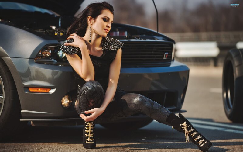 woman posing by car