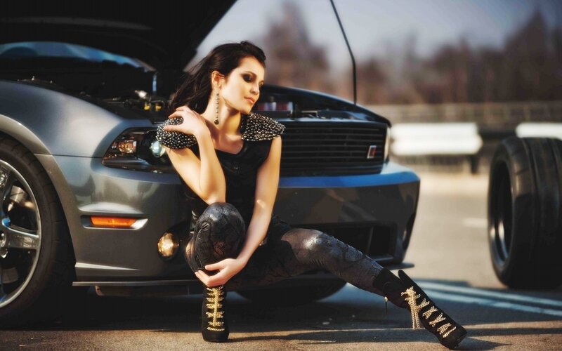 woman posing by car
