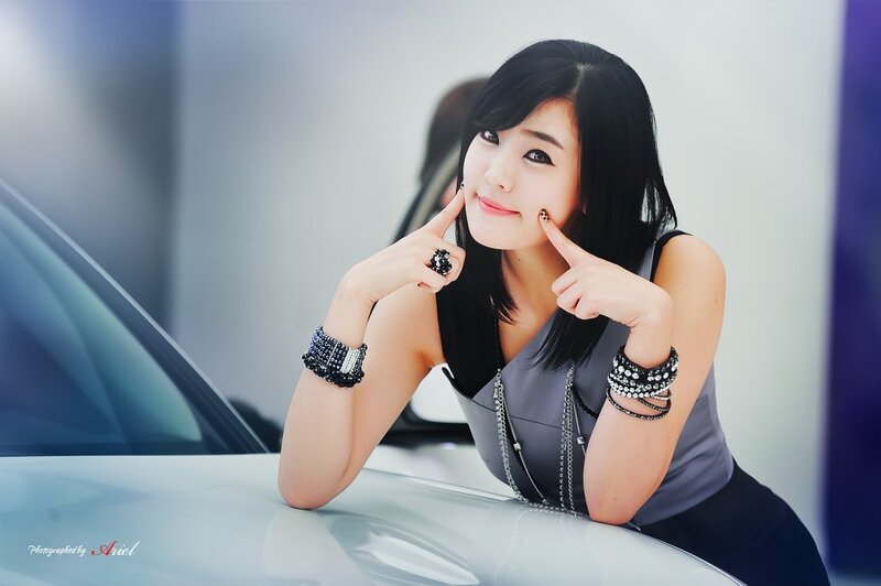 woman posing by car