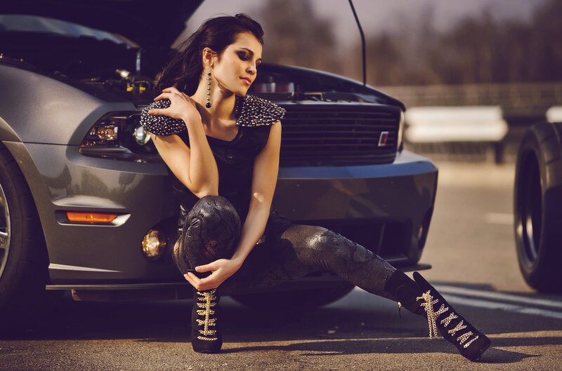 woman posing by car
