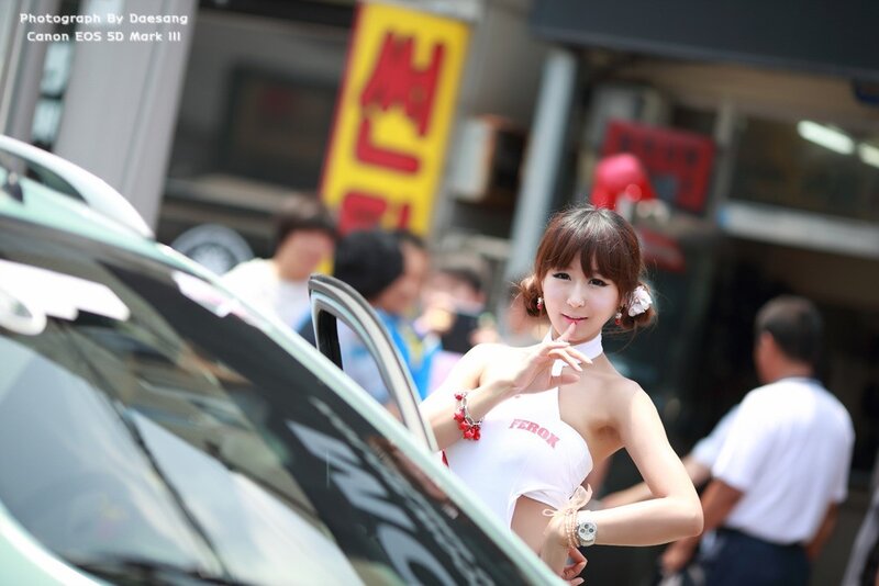 woman posing by car at event