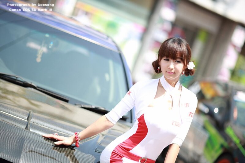 Woman posing by car at event
