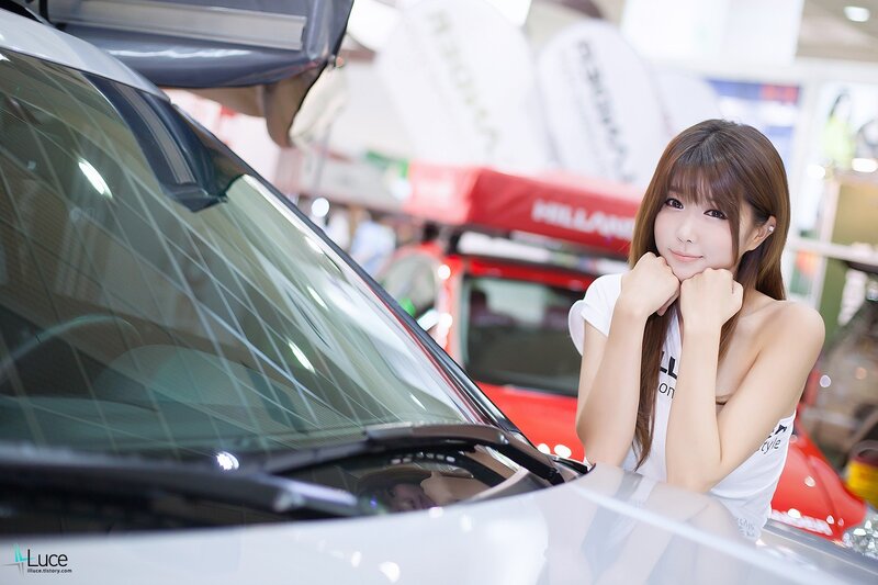 woman posing by car at show