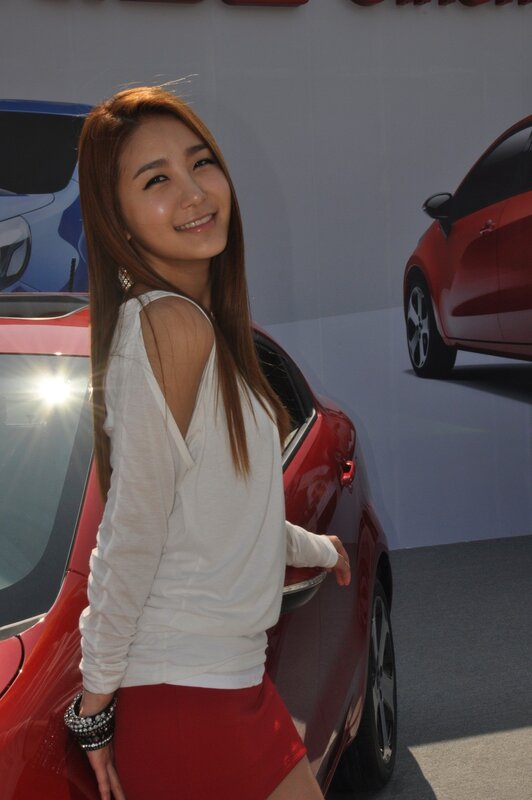 Woman Posing by Car — Red, Neutral, Afternoon